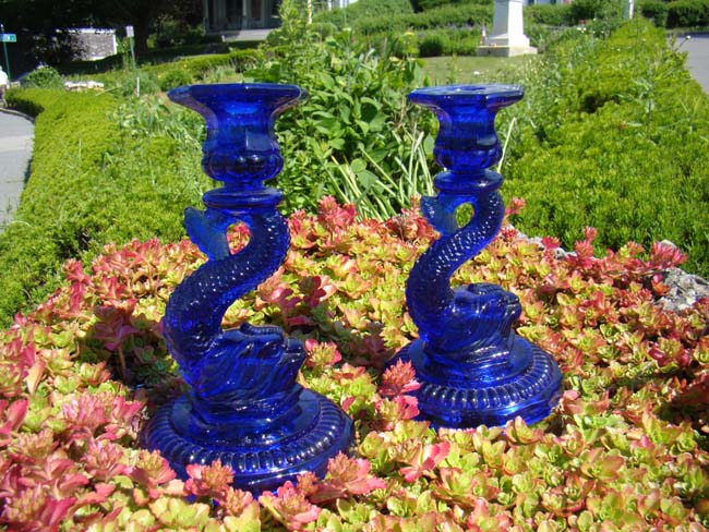 A gorgeous pair of cobalt blue dolphin form candlesticks